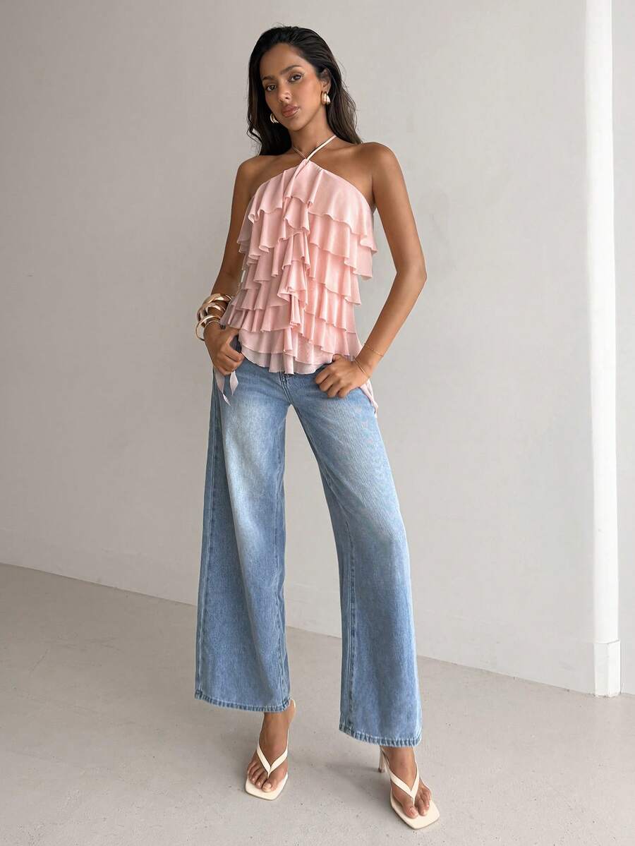 Women's sleeveless halter neck top featuring tiered ruffle layers, a backless cut, and an asymmetrical hem.