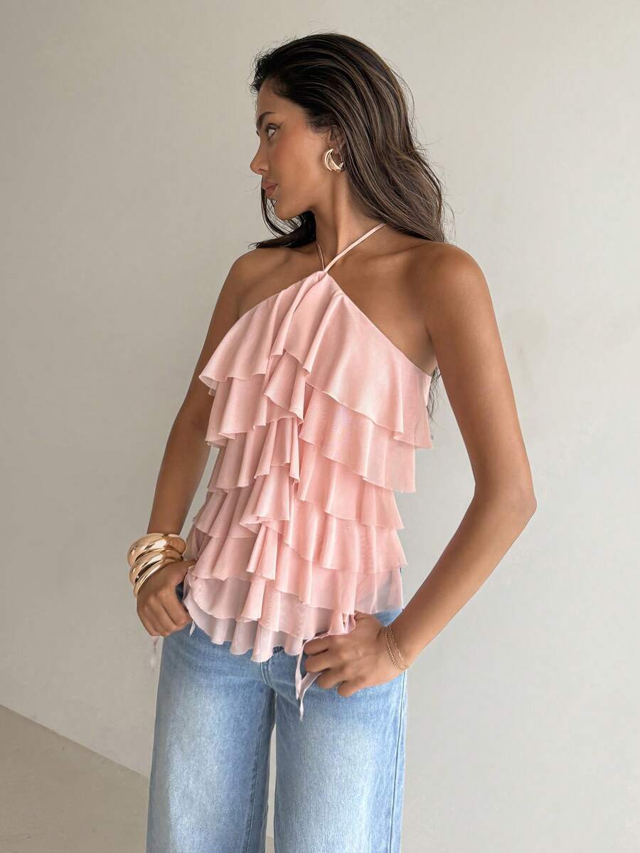 Women's sleeveless halter neck top featuring tiered ruffle layers, a backless cut, and an asymmetrical hem.