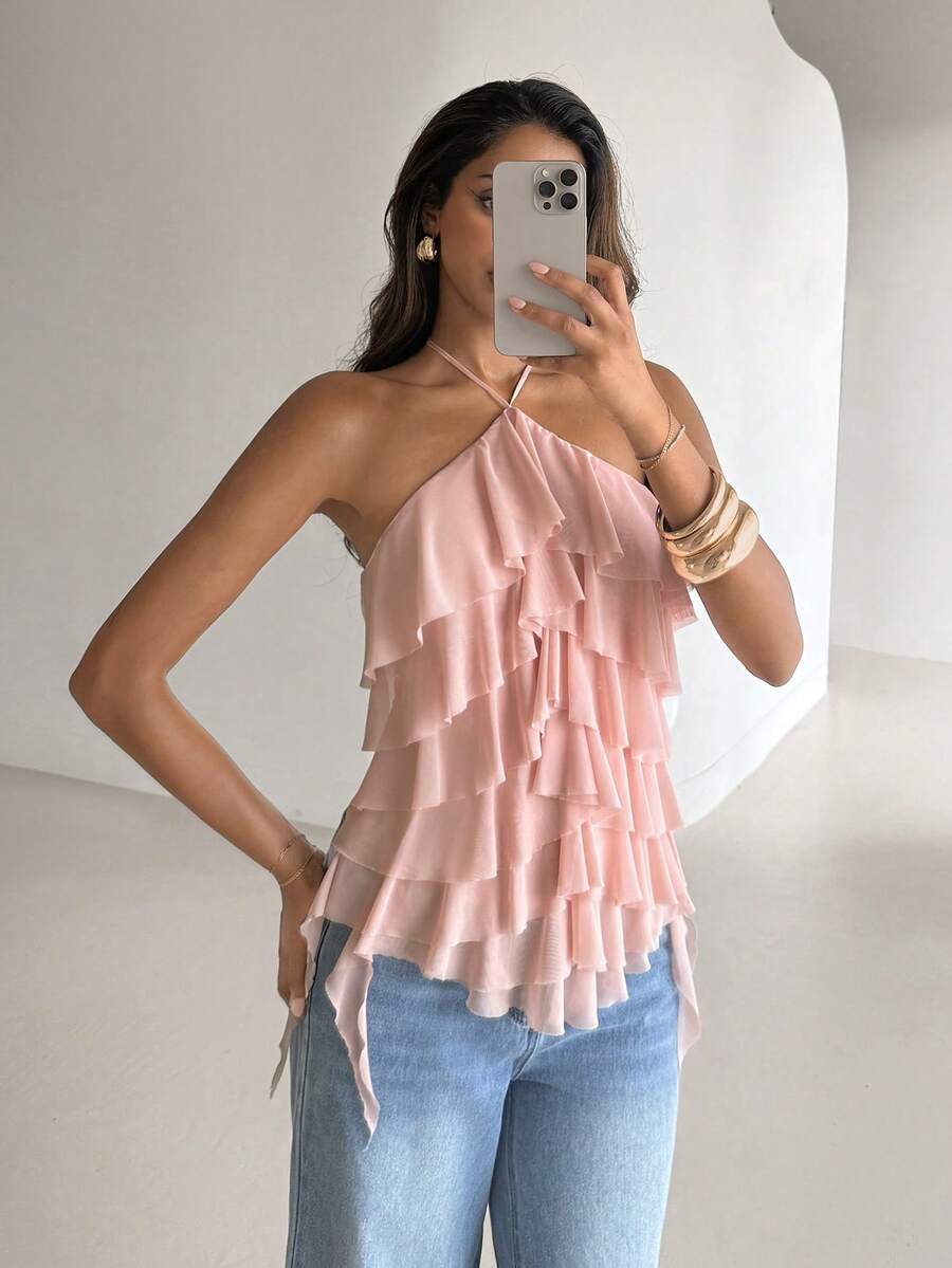 Women's sleeveless halter neck top featuring tiered ruffle layers, a backless cut, and an asymmetrical hem.