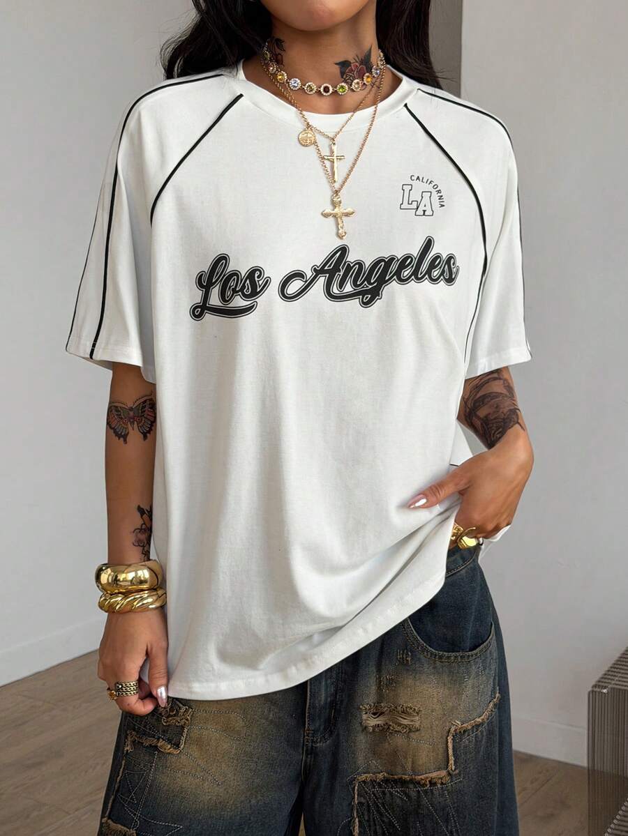 Yellow oversized graphic t-shirt featuring Brazil letter print on the front with contrast raglan sleeves and side stripe detailing.
