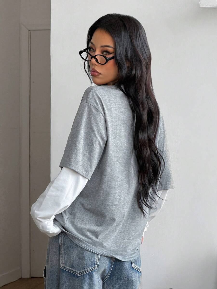 Women's casual graphic long sleeve t-shirt with a round neck, drop shoulder sleeves, and loose relaxed fit.