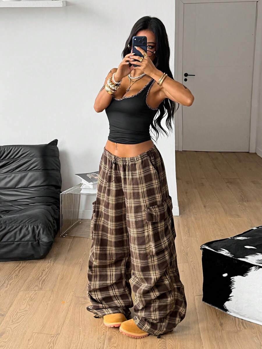 Women's loose fit parachute cargo pants featuring a drawstring waist and functional pockets in a casual streetwear style
