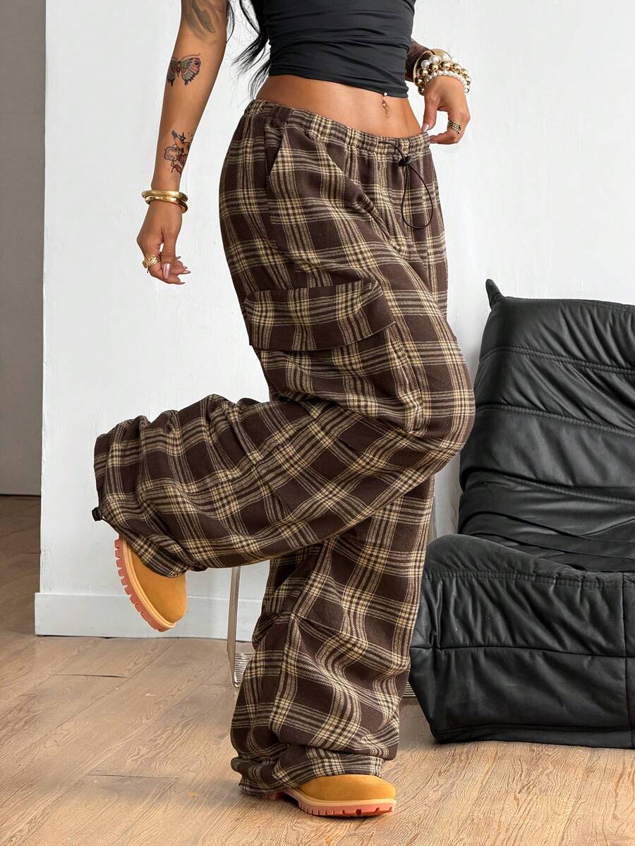 Women's loose fit parachute cargo pants featuring a drawstring waist and functional pockets in a casual streetwear style