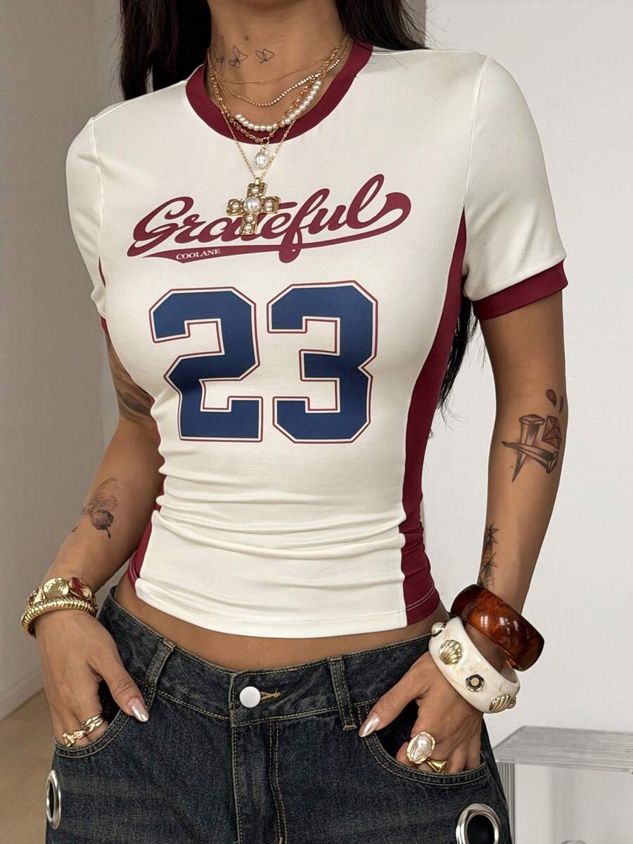 Women's short-sleeve slim fit knit jersey t-shirt featuring a round neck, letter embroidery, and contrast rib-knit trim.