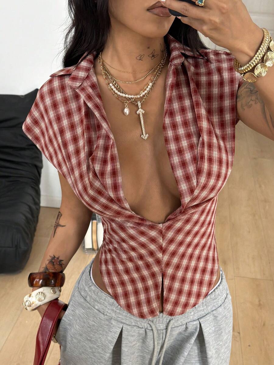 Women's plaid short sleeve shirt featuring a lapel collar and backless design in woven fabric.