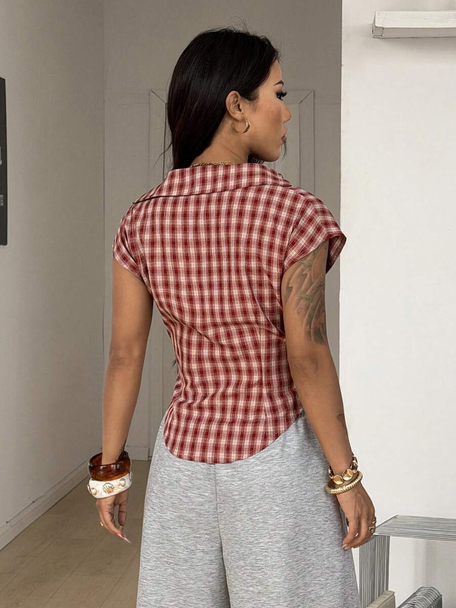 Women's plaid short sleeve shirt featuring a lapel collar and backless design in woven fabric.