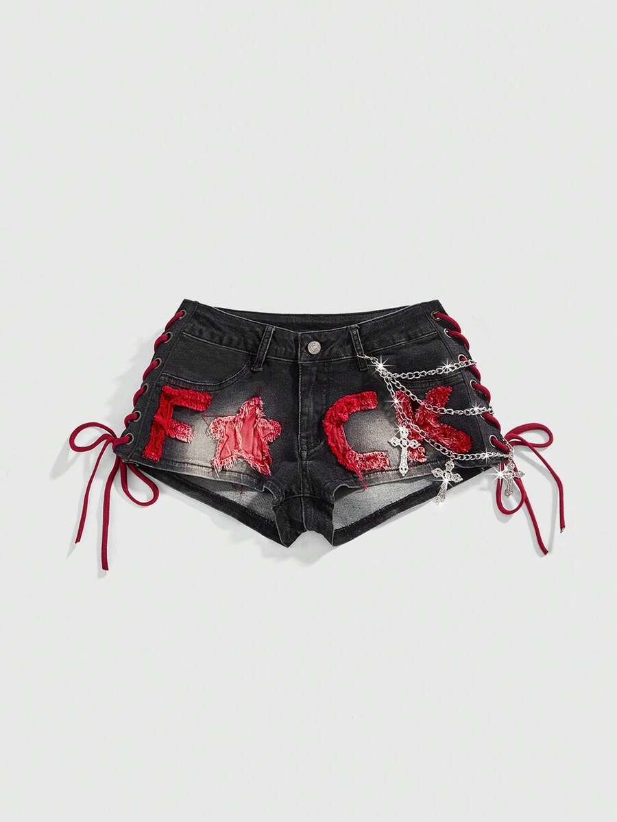 Women's Y2K low waist camo mini skort shorts featuring lace-up knot details, grommet eyelets, graphic lettering pattern, and a zipper fly.