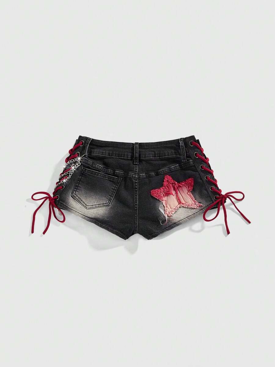 Women's Y2K low waist camo mini skort shorts featuring lace-up knot details, grommet eyelets, graphic lettering pattern, and a zipper fly.