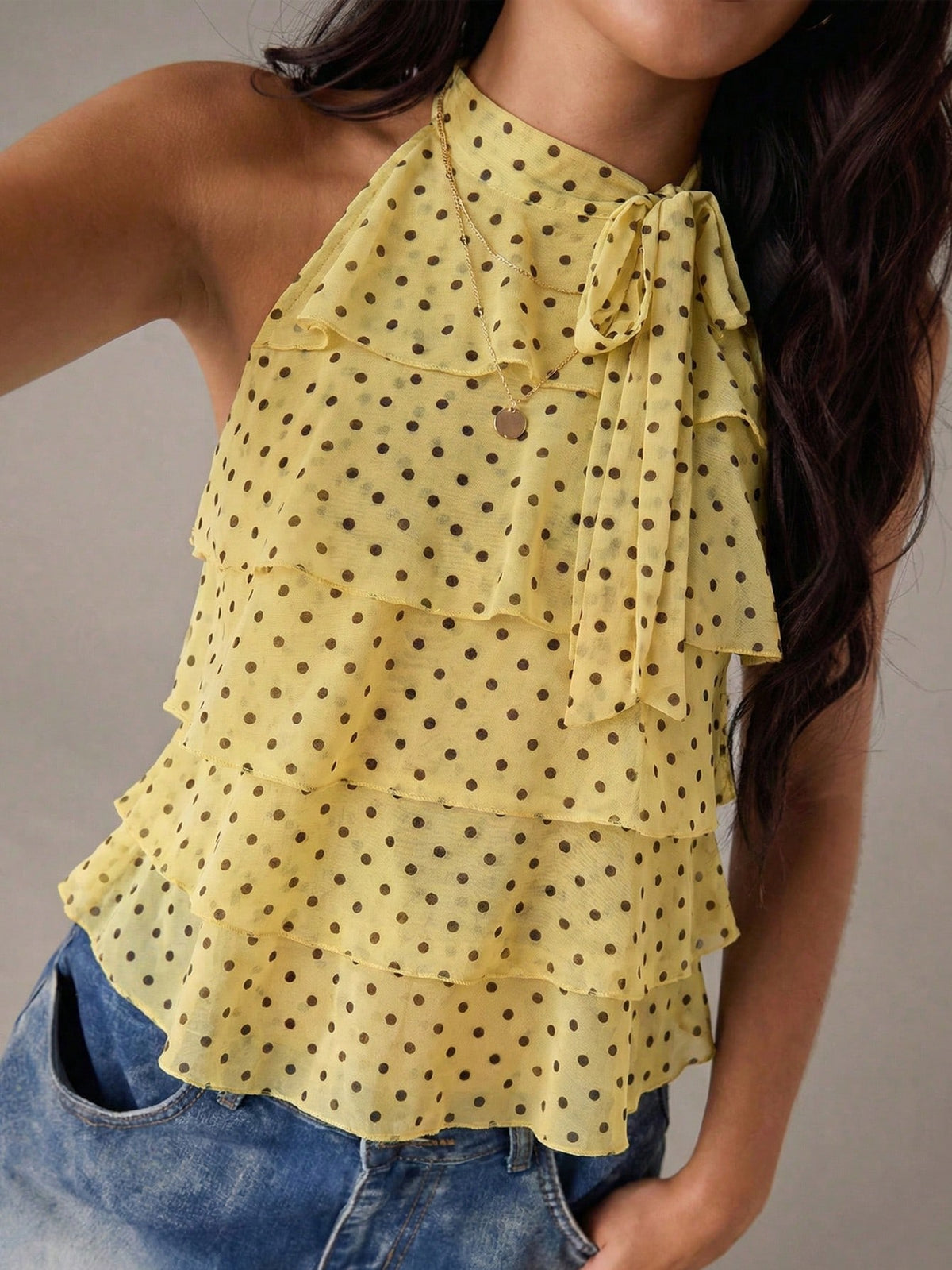 Women's sleeveless stand collar top in rib-knit fabric featuring button and hollow-out details.