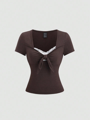 Women's casual short sleeve rib-knit t-shirt with a square neckline, contrast lace detailing, and ruched front.