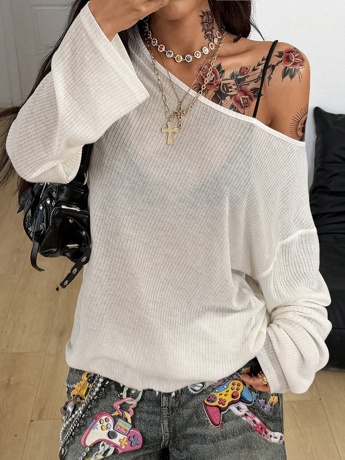 Women's off the shoulder long sleeve t-shirt featuring an asymmetrical neckline and loose fit in soft knitted fabric.