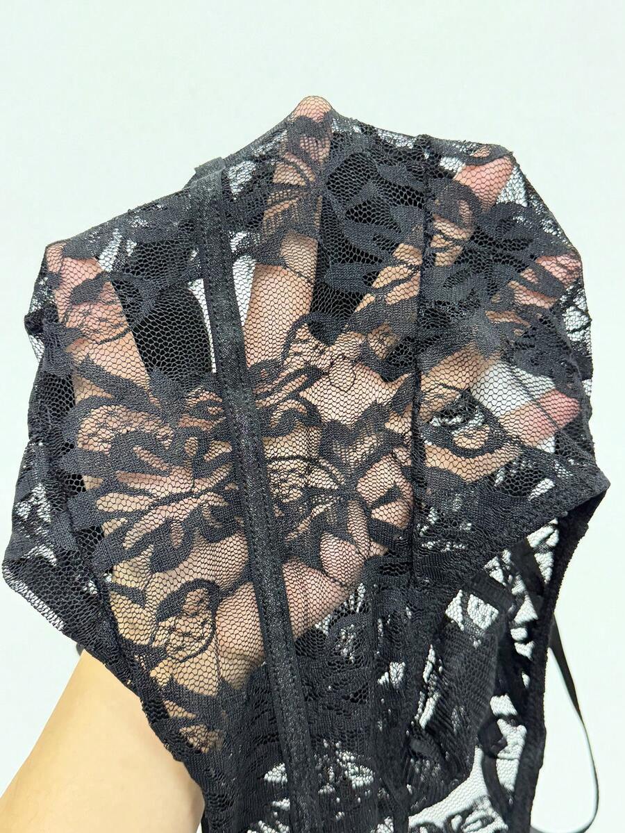 Fitted women's lace and mesh cami bodysuit with spaghetti straps.
