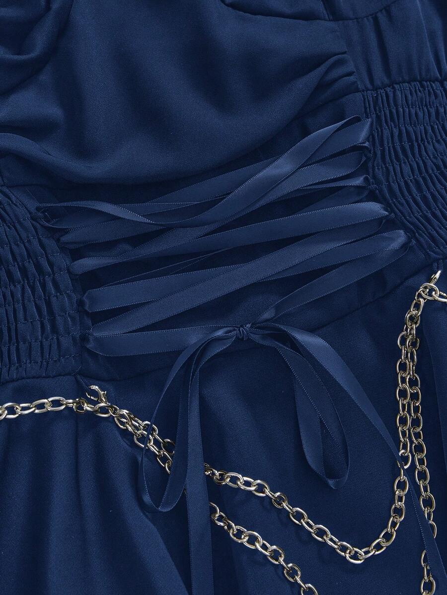 Women's vintage gothic cami dress with high-waist lace-up detail, spaghetti straps, zipper closure, and an asymmetrical knee-length hem.