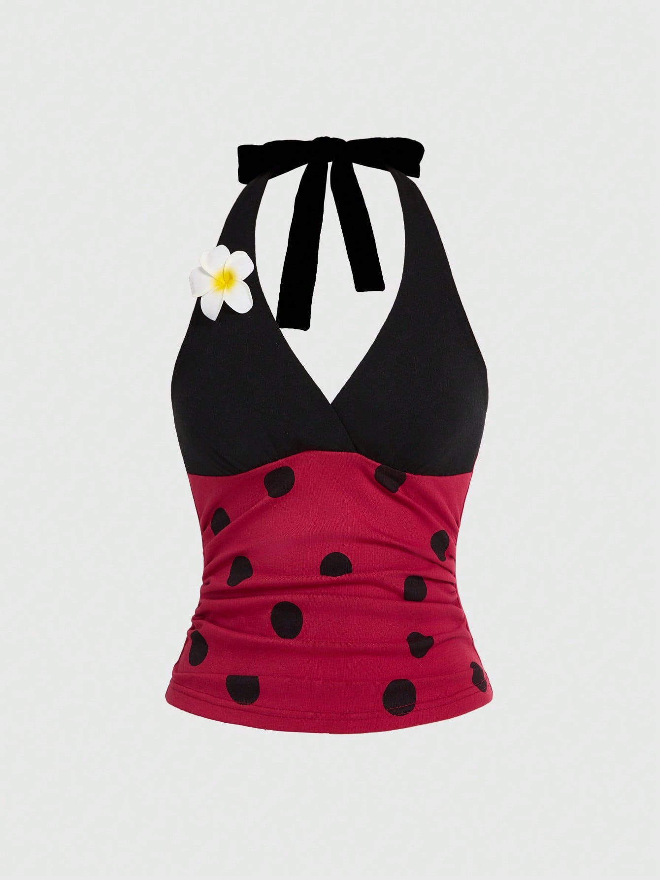 Women's black and white halter neck tank top with ladybug and daisy decor, geometric pattern, ruched front, knot detail, and backless design.