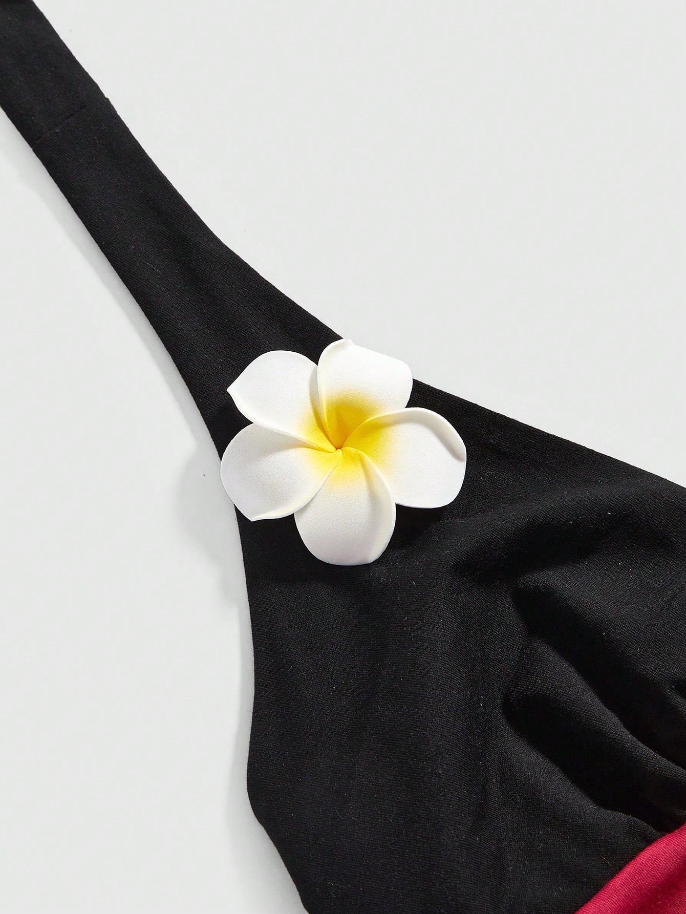 Women's black and white halter neck tank top with ladybug and daisy decor, geometric pattern, ruched front, knot detail, and backless design.