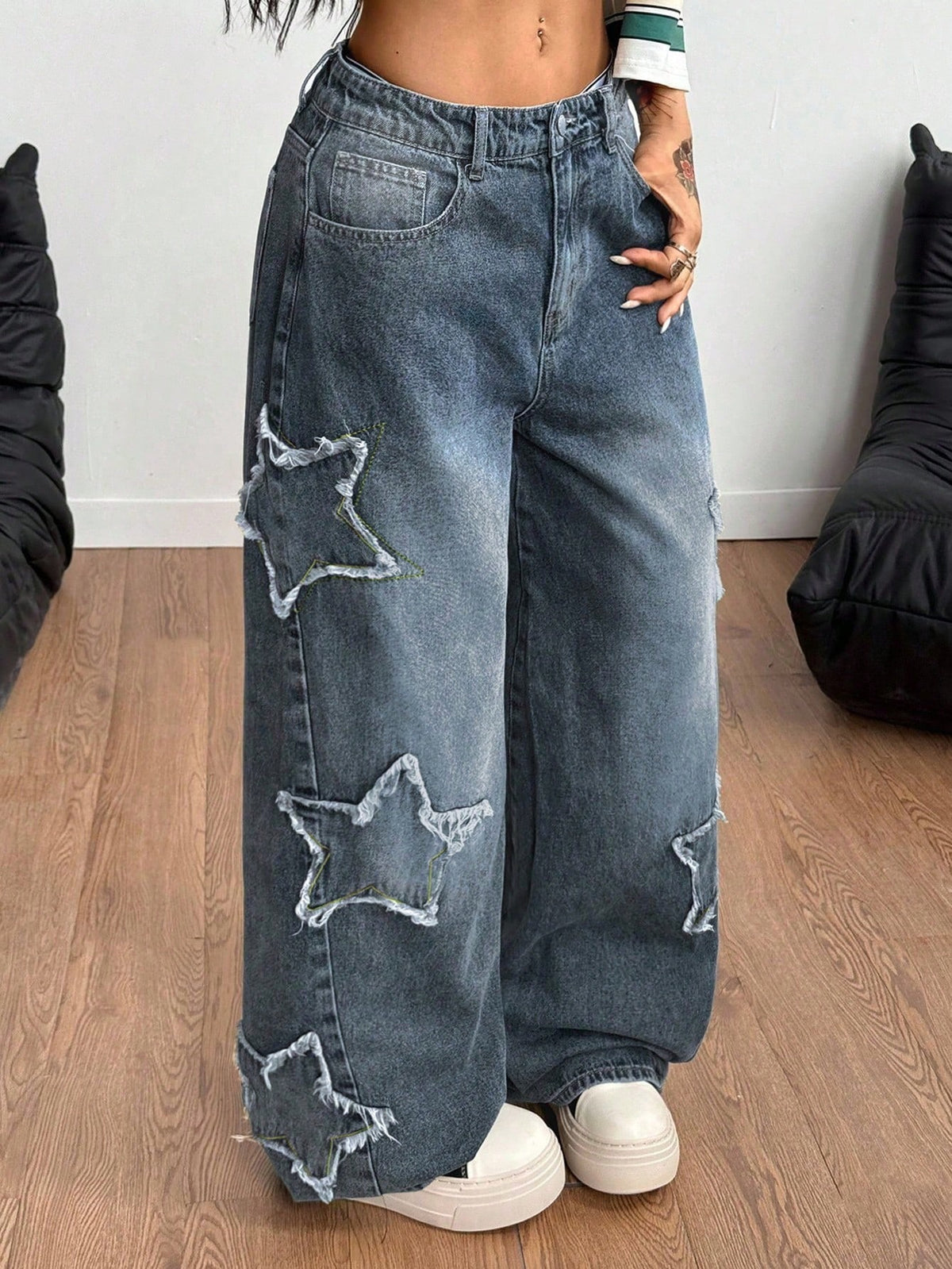 Front view of women's loose wide leg denim jeans featuring a mid waist, classic front pockets, and a zipper fly closure.