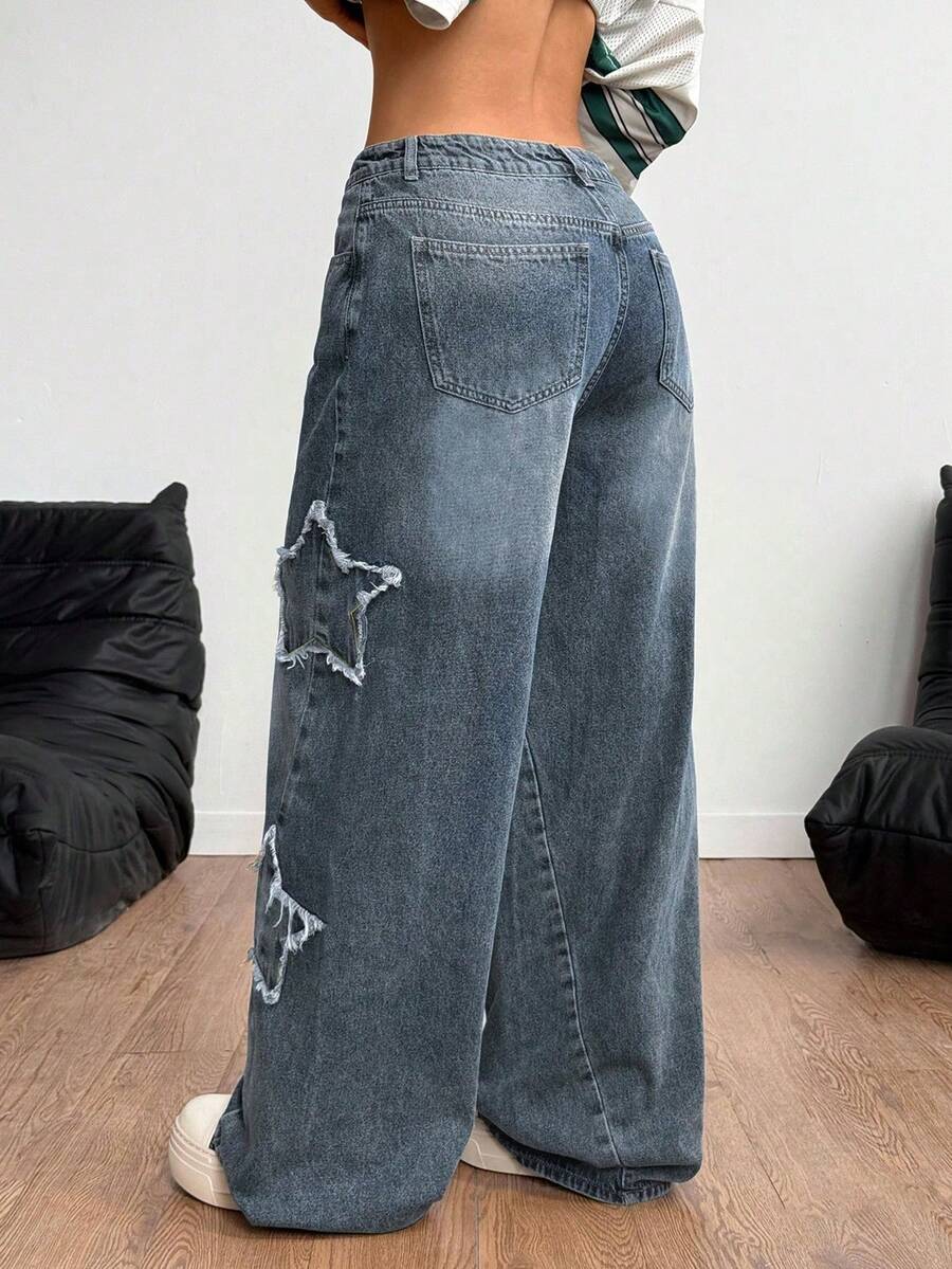 Front view of women's loose wide leg denim jeans featuring a mid waist, classic front pockets, and a zipper fly closure.