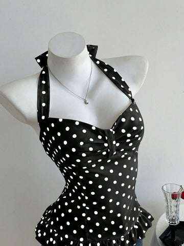 Women's polka dot halter camisole with bow bust detail, ruched and shirred design, slim crop fit, and flared ruffle hem.