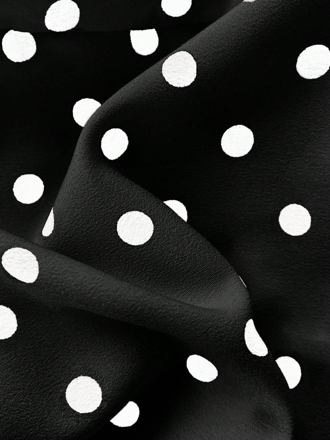 Women's polka dot halter camisole with bow bust detail, ruched and shirred design, slim crop fit, and flared ruffle hem.
