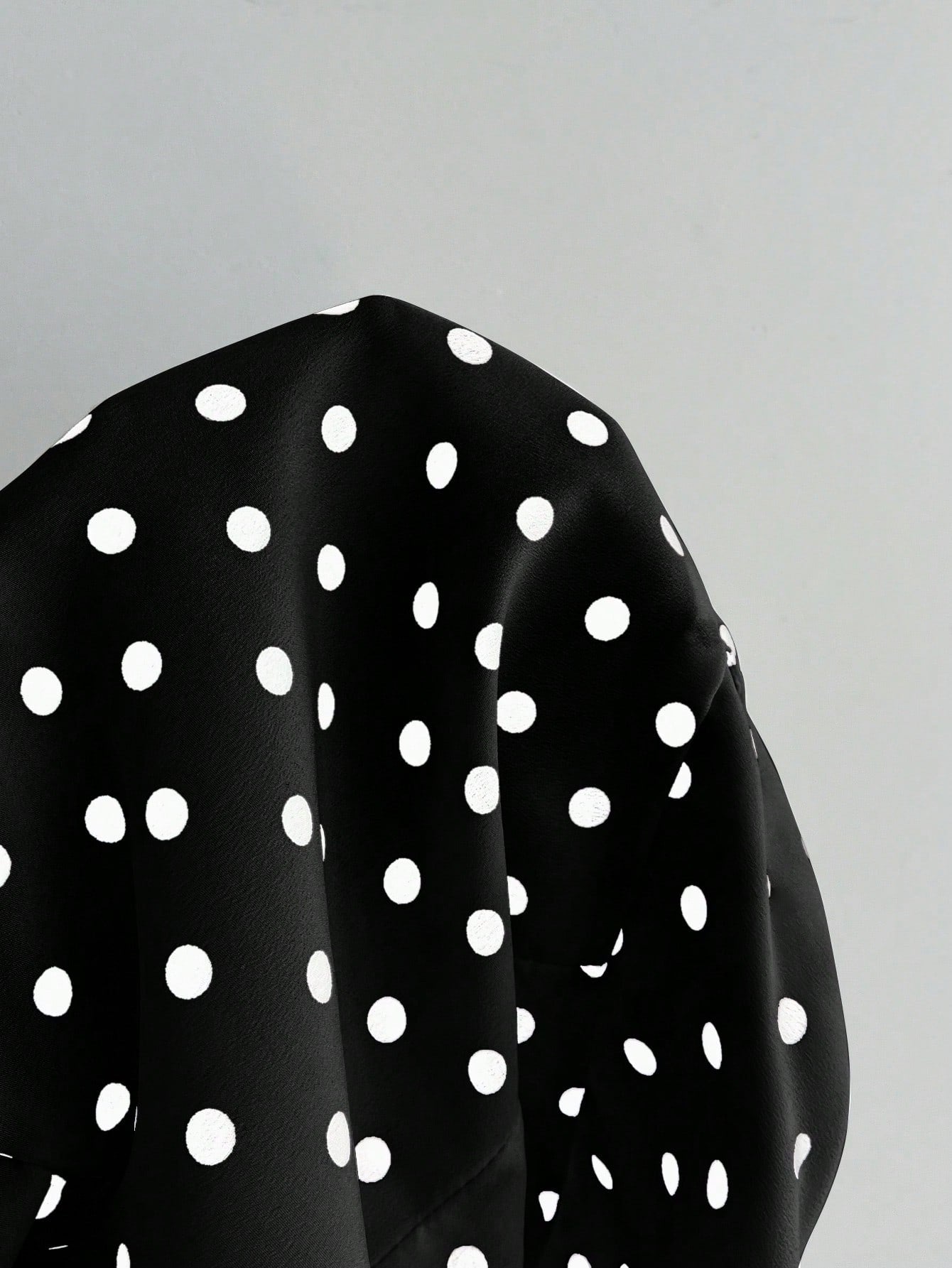 Women's polka dot halter camisole with bow bust detail, ruched and shirred design, slim crop fit, and flared ruffle hem.
