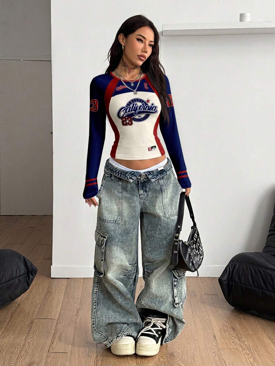Women's slim fit long sleeve raglan t-shirt with collegiate letter graphic print, round neck, and contrast binding.