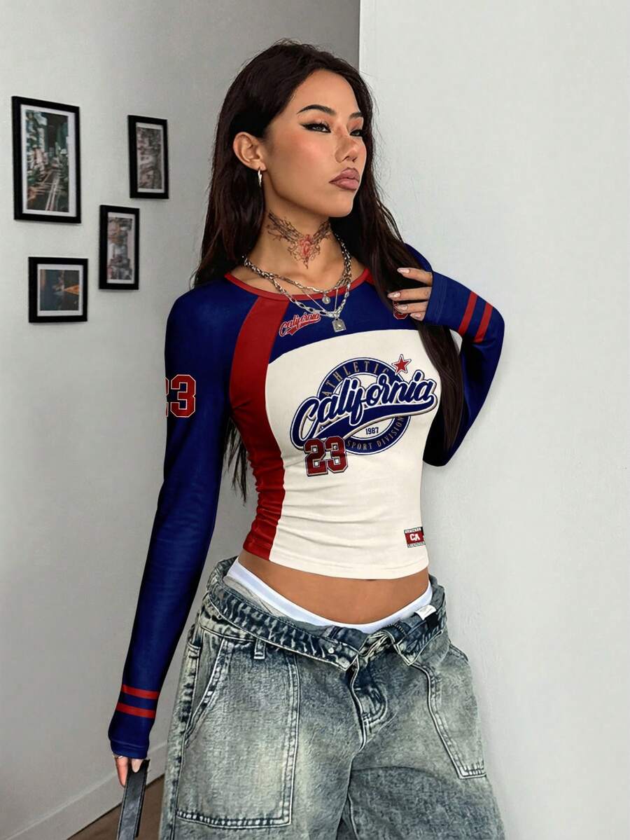 Women's slim fit long sleeve raglan t-shirt with collegiate letter graphic print, round neck, and contrast binding.