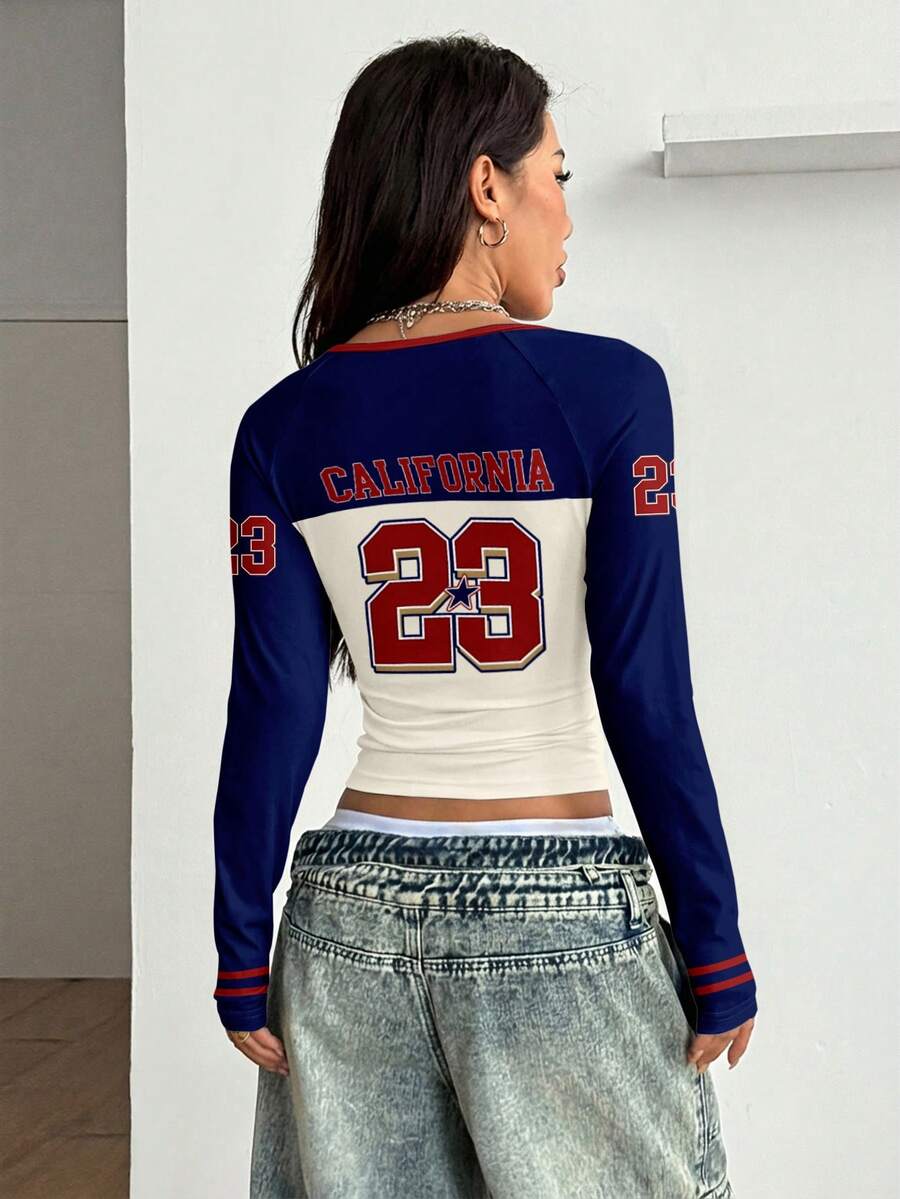 Women's slim fit long sleeve raglan t-shirt with collegiate letter graphic print, round neck, and contrast binding.
