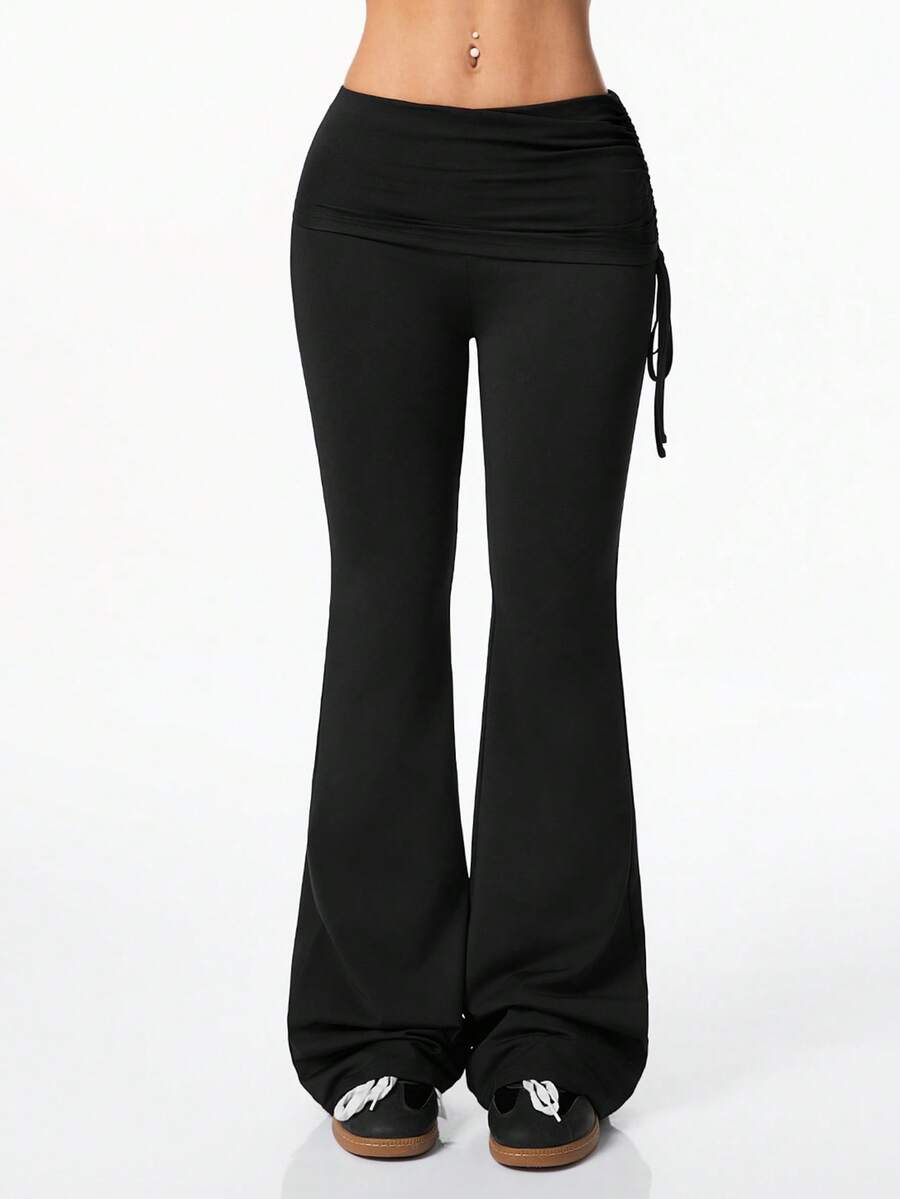 Women's striped flare leg pants featuring a mid-rise waist, slim fit thigh, and ruched side drawstring detail in stretch knit fabric.