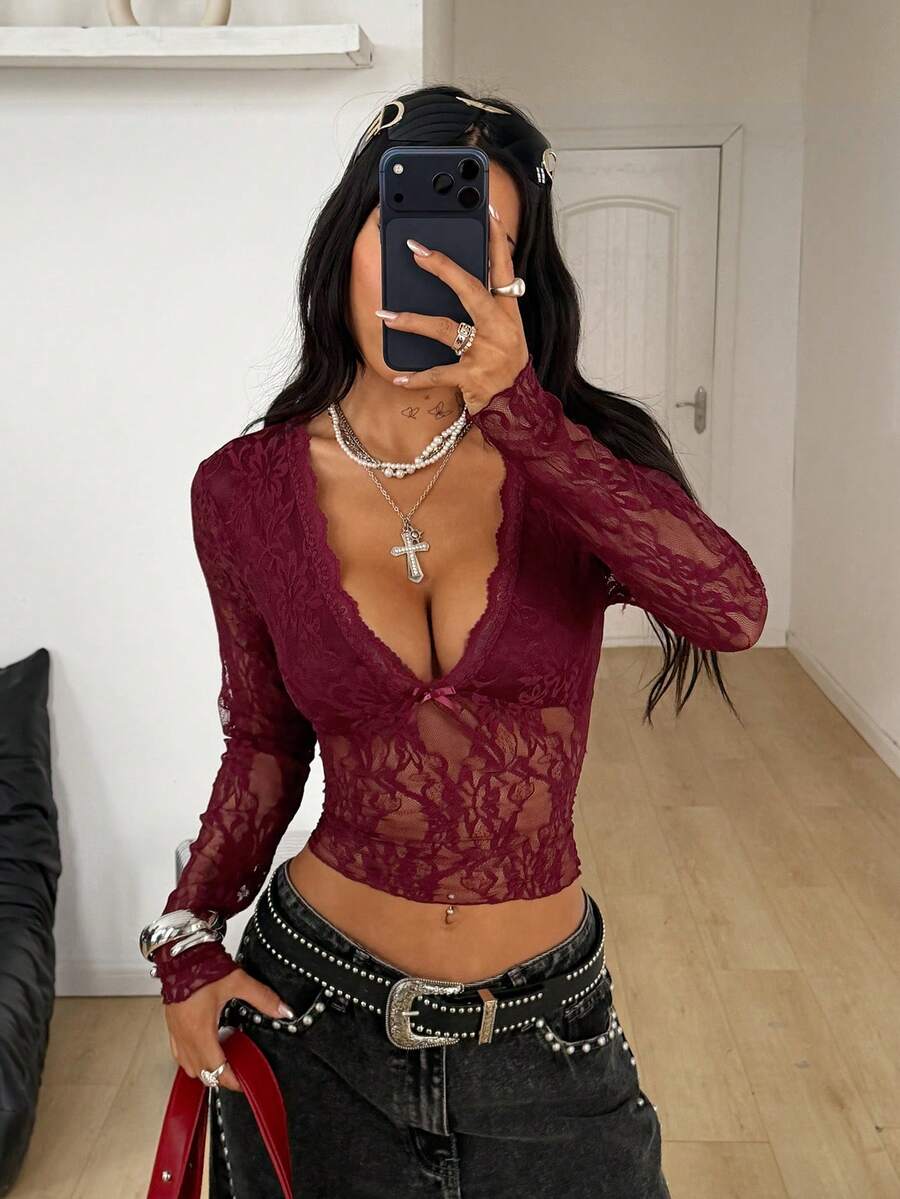 Women's polka dot sheer mesh crop blouse featuring contrast scallop lace trim along the V-neckline and long sleeves in a slim fit silhouette.