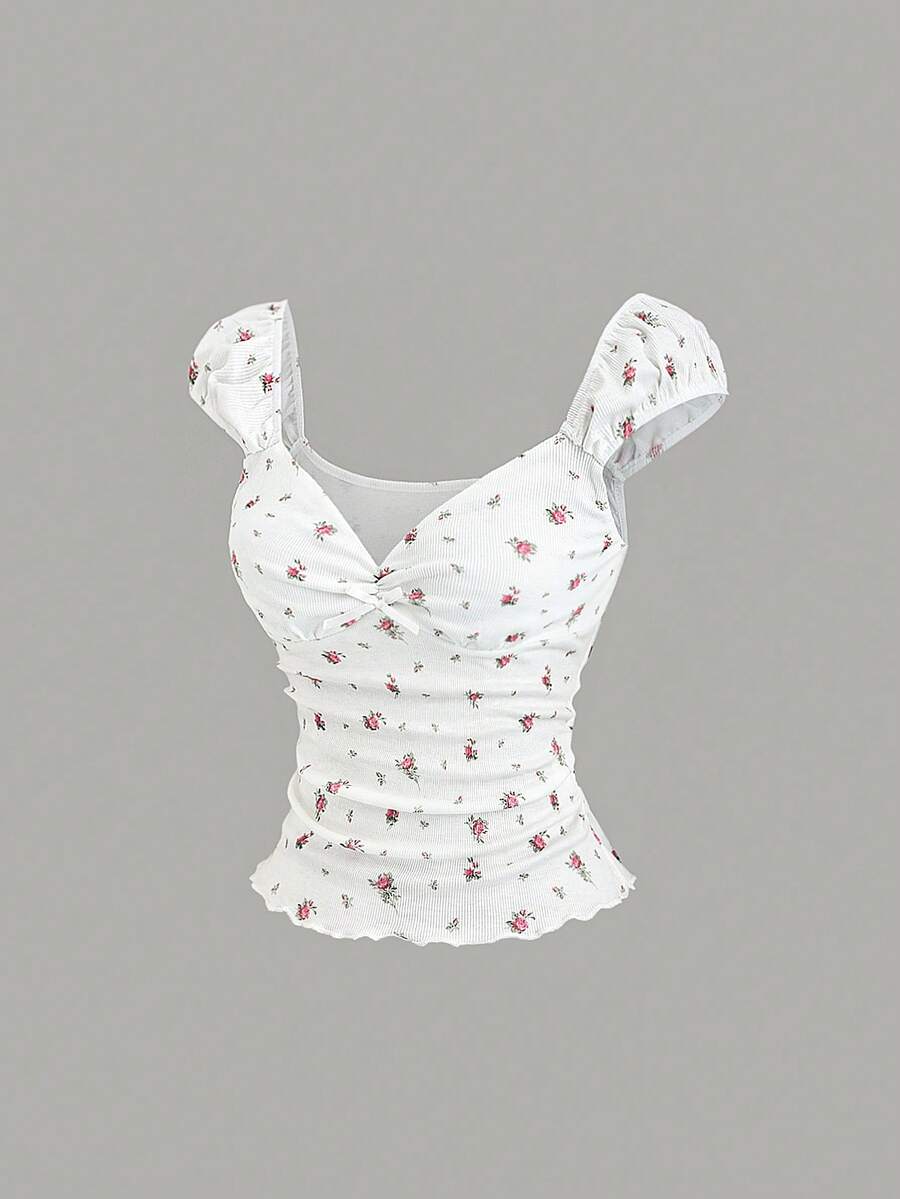 Women's short sleeve knit top with a sweetheart neckline and ruched twist knot front detail.