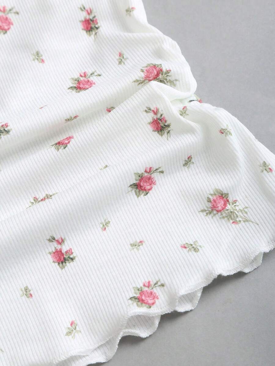 Women's short sleeve knit top with a sweetheart neckline and ruched twist knot front detail.