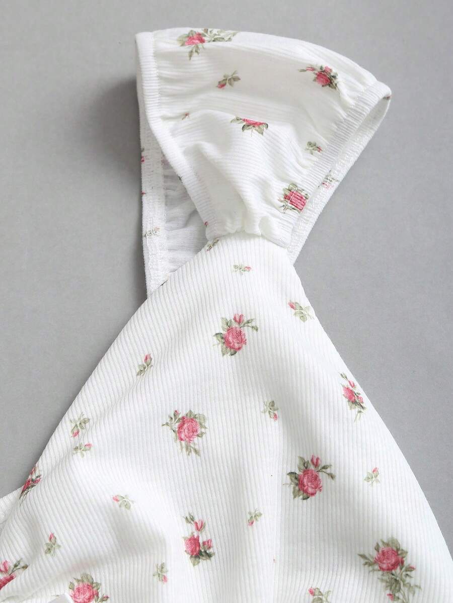 Women's short sleeve knit top with a sweetheart neckline and ruched twist knot front detail.