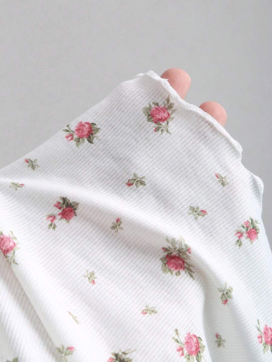 Women's short sleeve knit top with a sweetheart neckline and ruched twist knot front detail.