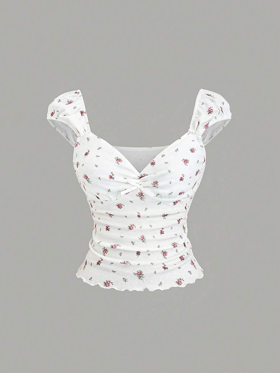 Women's short sleeve knit top with a sweetheart neckline and ruched twist knot front detail.