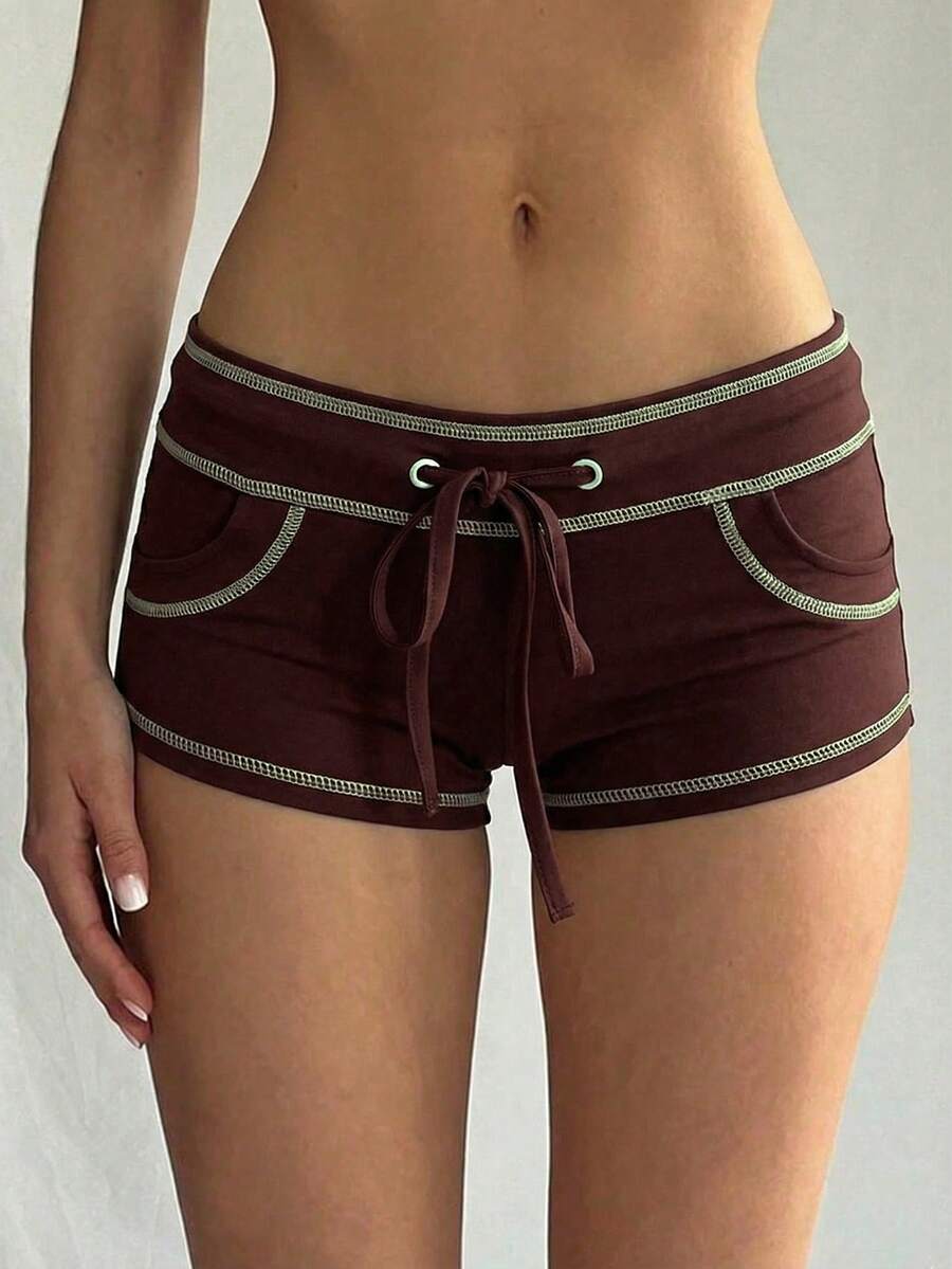 Women's low waist track shorts with drawstring waist, zipper detail, and mini length in a casual skinny fit