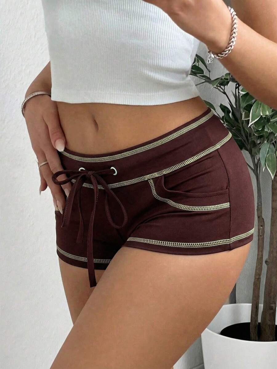 Women's low waist track shorts with drawstring waist, zipper detail, and mini length in a casual skinny fit