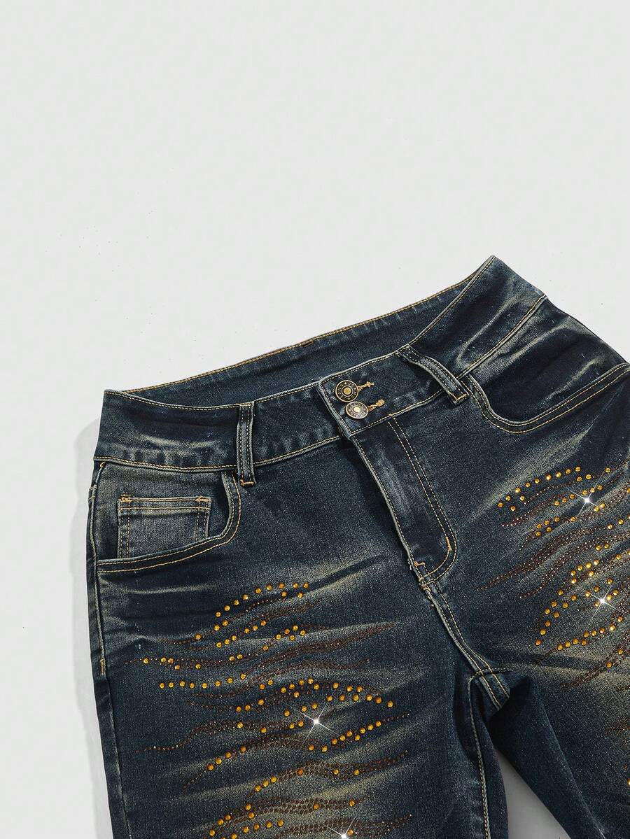Women's ultra low-rise skinny denim shorts featuring sparkling gold rhinestone embellishments with front pockets and zipper fly.