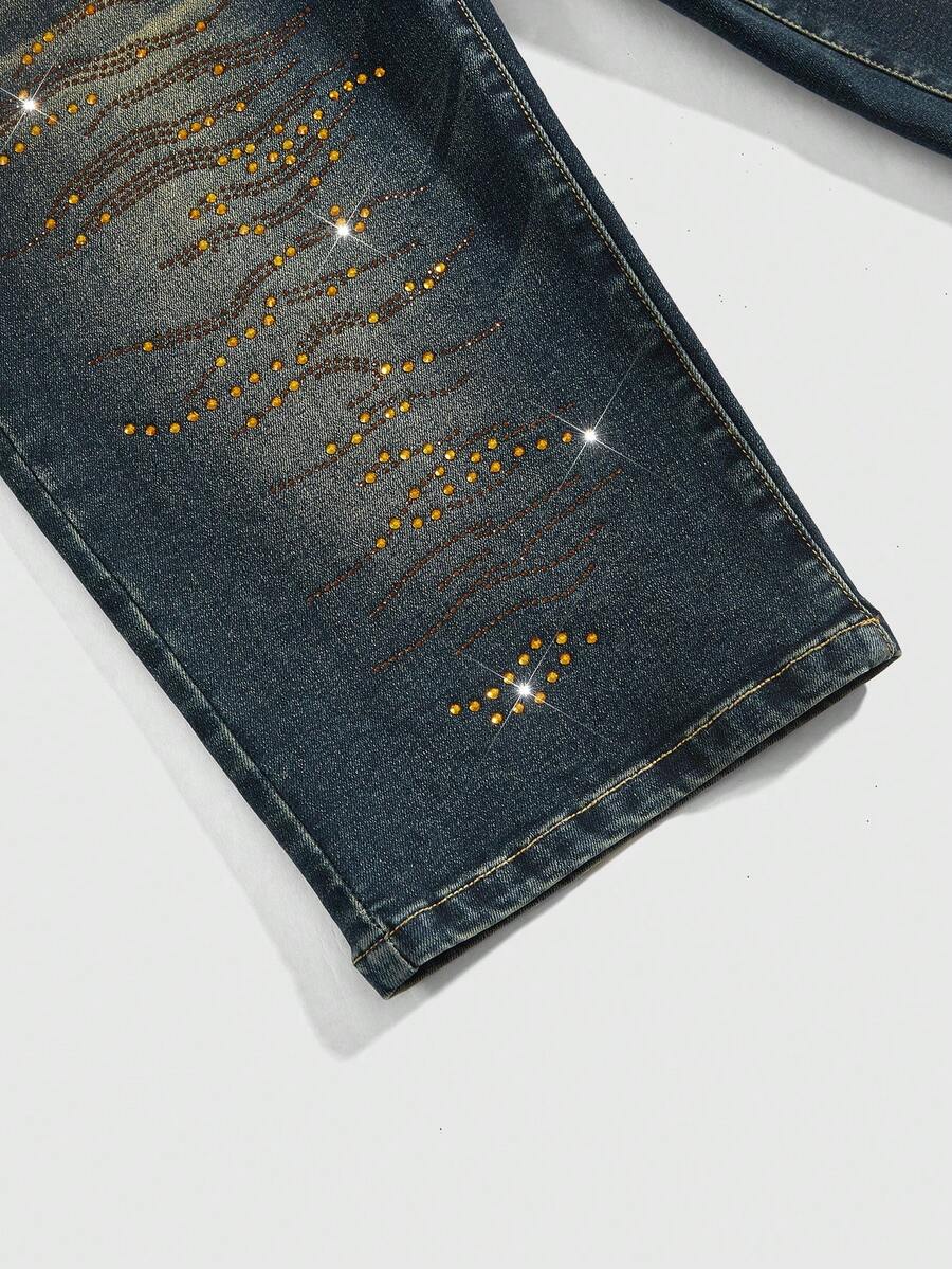 Women's ultra low-rise skinny denim shorts featuring sparkling gold rhinestone embellishments with front pockets and zipper fly.