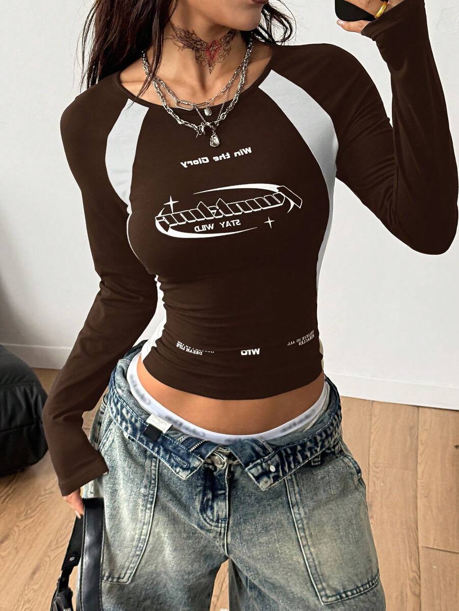 Women's slim fit long sleeve raglan t-shirt with collegiate letter graphic print, round neck, and contrast binding.