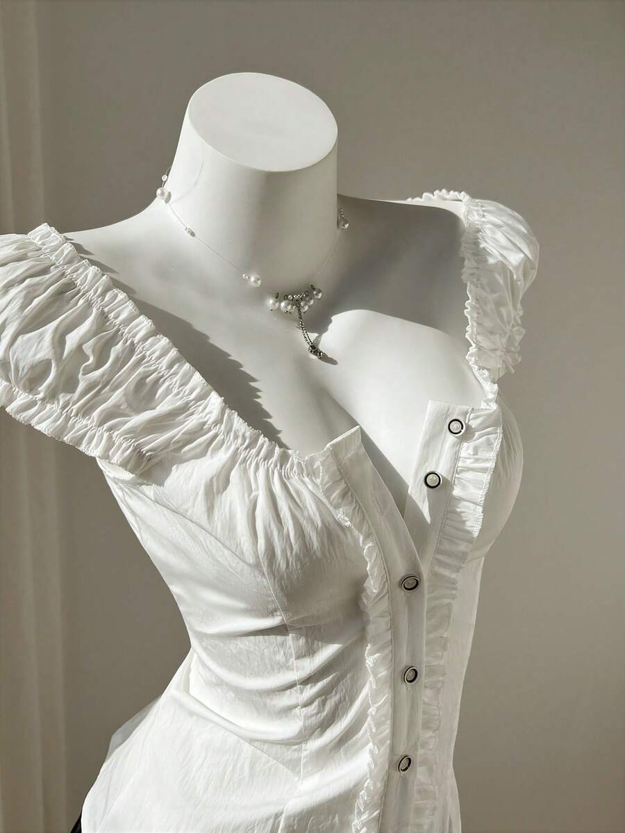 Women's black off-shoulder cap sleeve blouse with ruffled detailing and a tie-back design.
