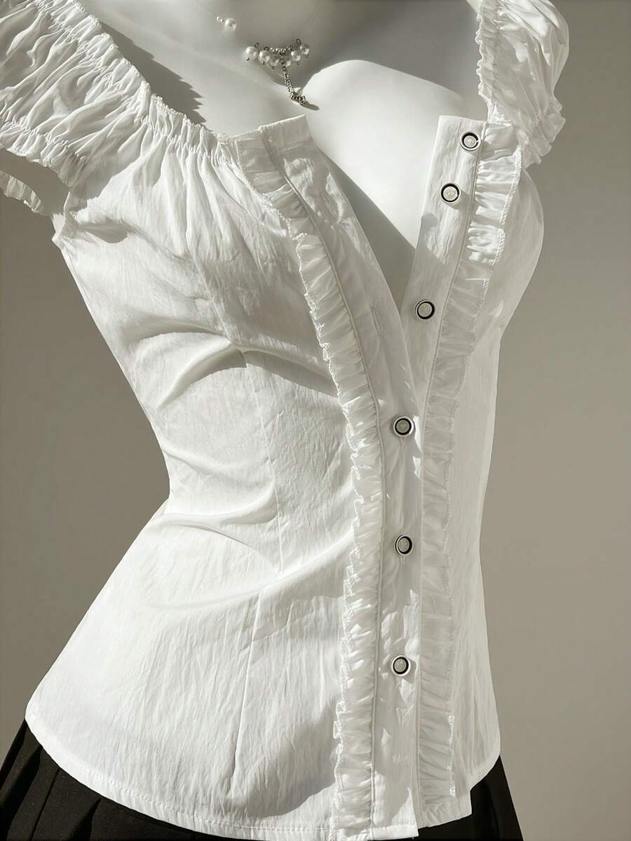 Women's black off-shoulder cap sleeve blouse with ruffled detailing and a tie-back design.