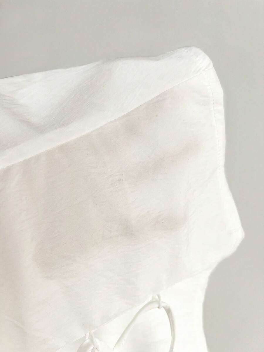 Women's black off-shoulder cap sleeve blouse with ruffled detailing and a tie-back design.