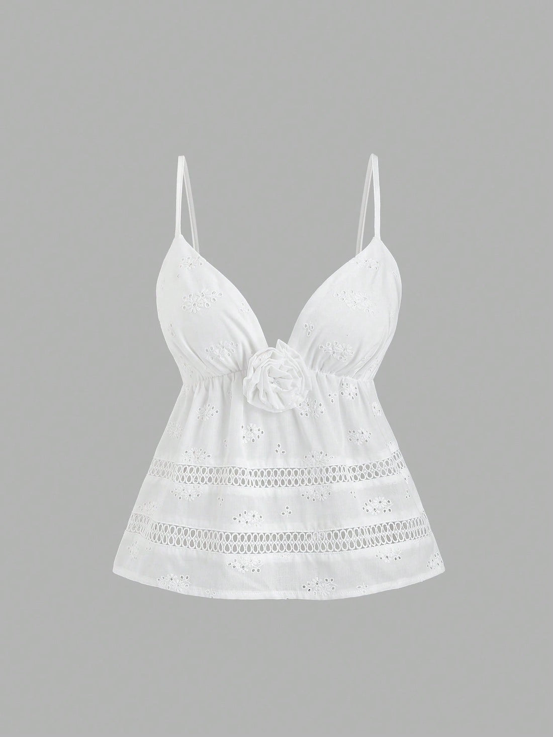 Women's white spaghetti strap cami top with eyelet embroidery, knot detail, ruffle hem, and flared hem shape