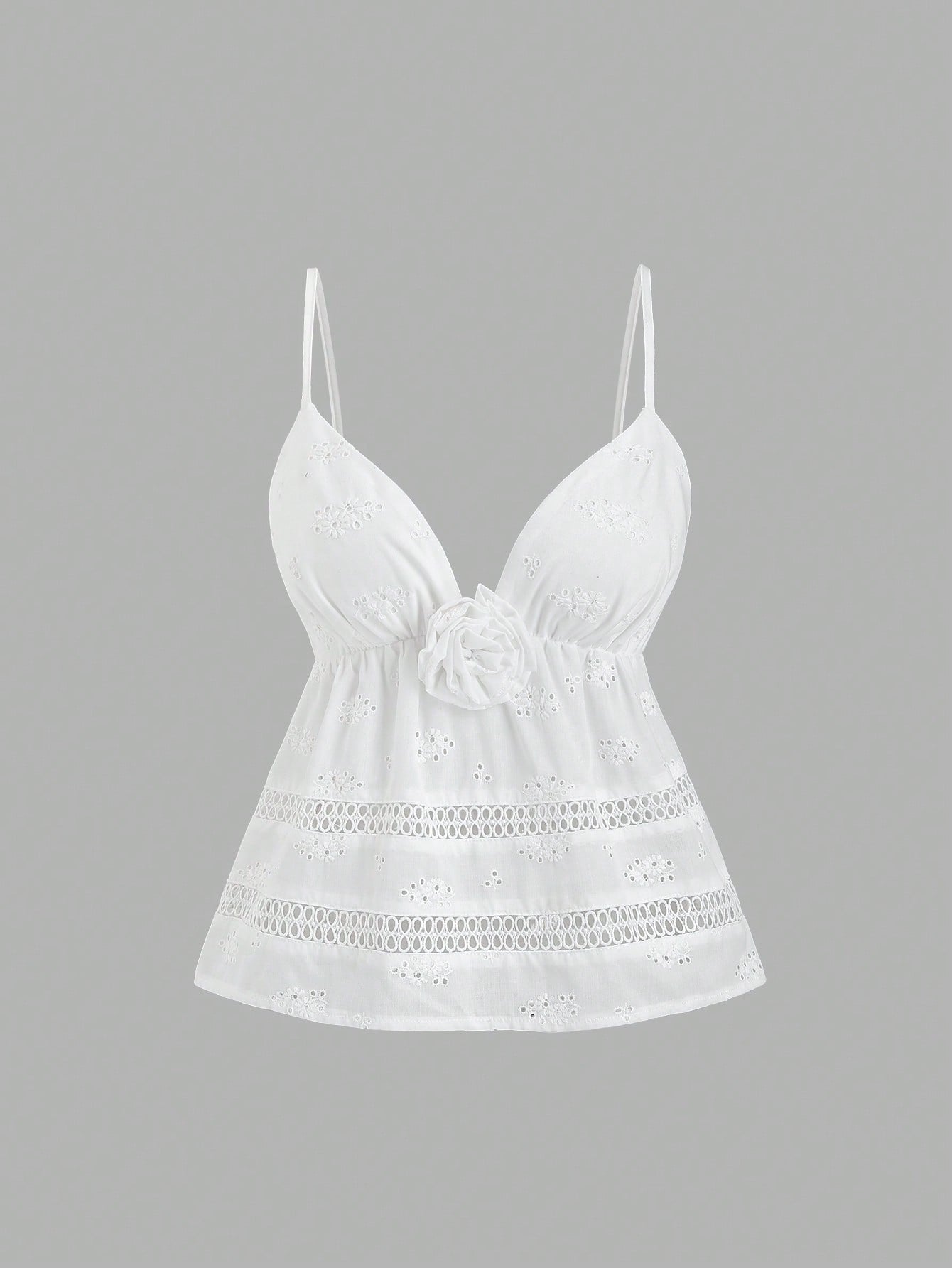 Women's white spaghetti strap cami top with eyelet embroidery, knot detail, ruffle hem, and flared hem shape