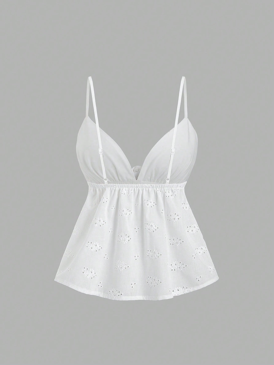 Women's white spaghetti strap cami top with eyelet embroidery, knot detail, ruffle hem, and flared hem shape