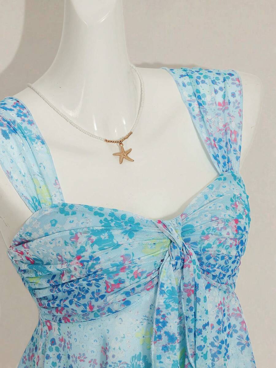Women's white cherry print cami top with wide straps, ruched knot detail, and an asymmetrical hem