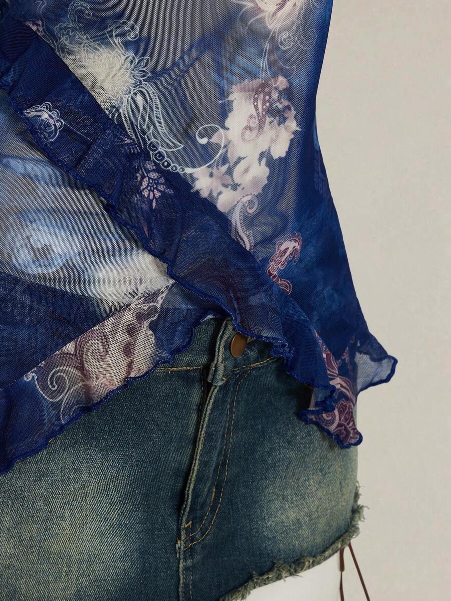 Women's graphic print camisole top featuring thin spaghetti straps, a backless cut, and an asymmetrical hem.