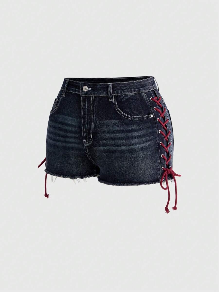 Plus size black gothic mini shorts with heart embroidery, graphic pocket pattern, lace-up detail, raw hem, and zipper fly