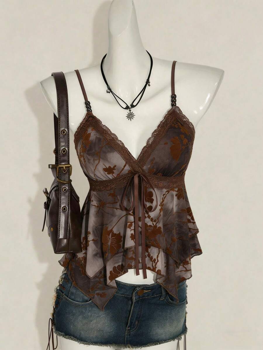 Women's black spaghetti strap tank top featuring contrast lace details, asymmetric ruffle hem, and slim fit design.