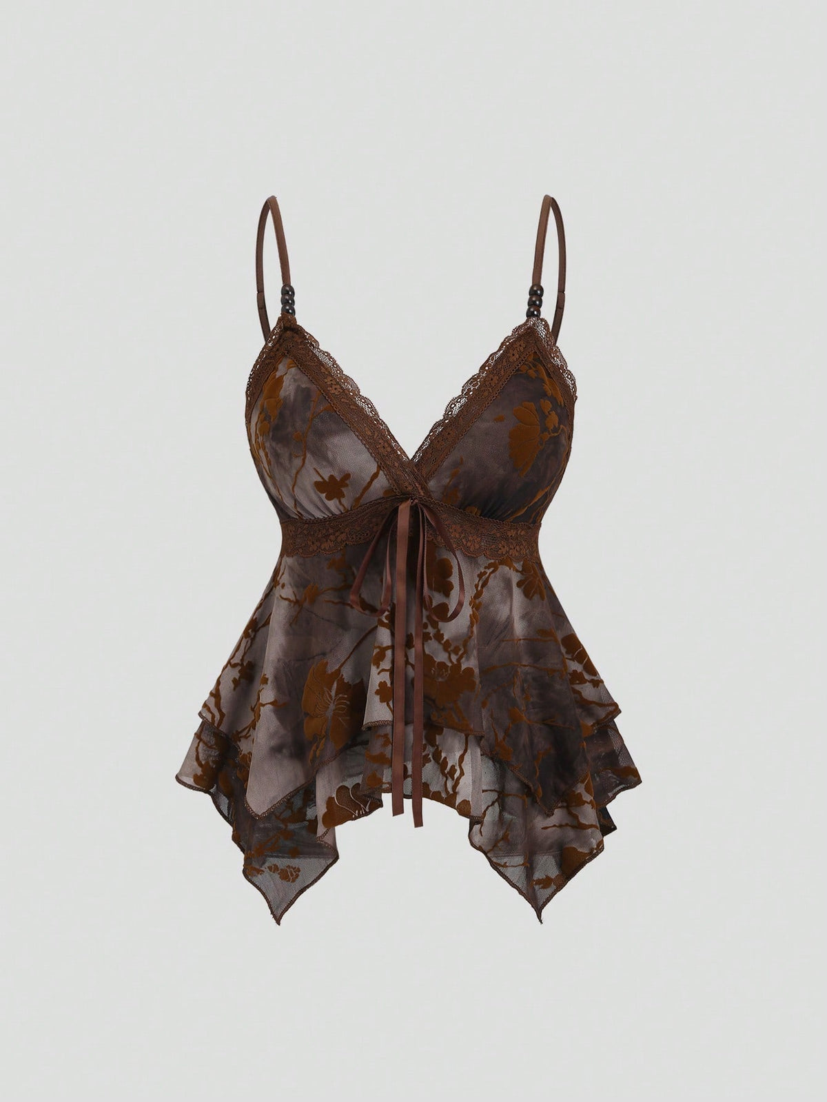 Women's black spaghetti strap tank top featuring contrast lace details, asymmetric ruffle hem, and slim fit design.